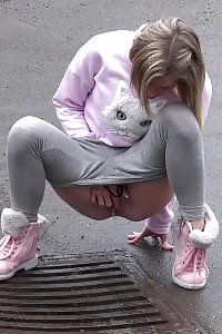 Light-haired Beauty Claudia Pisses Down A Drain Outside