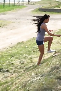 Dazzling Black Haired Model Pisses Near Some Stones