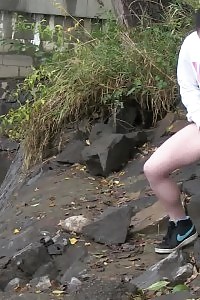 Brunette Bitch Pisses Next To A Flowing River