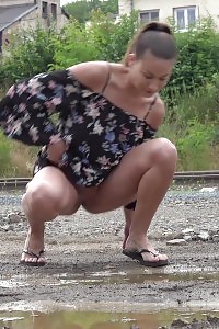 Beautiful Black-haired Yenna Squats And Pissing In A Puddle